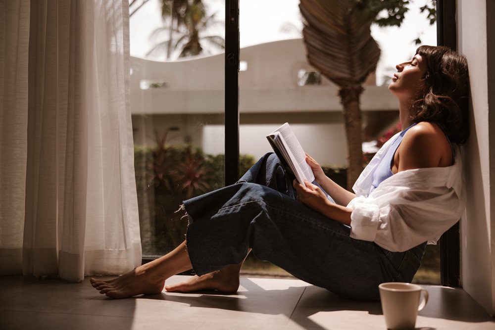 close-up-view-cute-woman-with-book-home